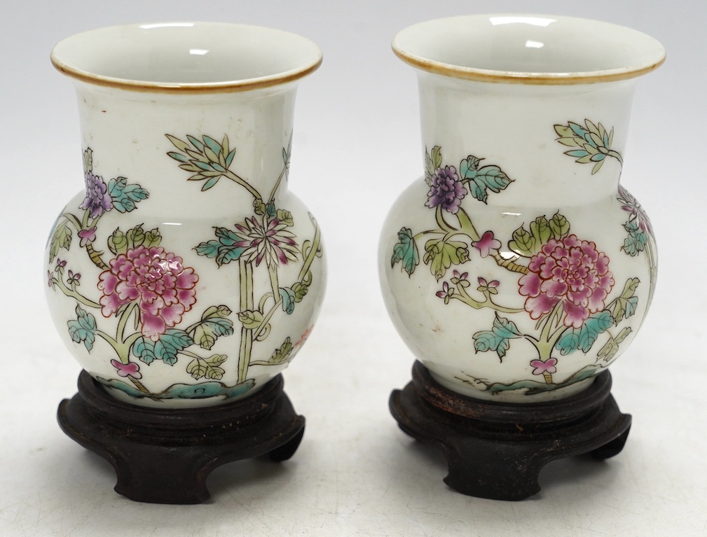A pair of Chinese famille rose vases, mid 20th century, on wood stands, 10cm high. Condition - good